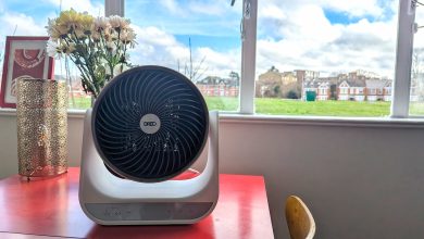 The Dreo Smart Whole Room Heater 714s on a red table, in front of a window