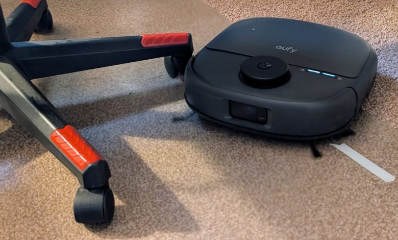 The Eufy Omni C28 pictured cleaning around the legs of an office chair