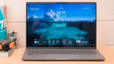 The Asus Zenbook A14 pictured from the front on a wood workbench