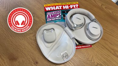 Bose QC Ultra earbuds and headphones in their cases on a copy of What Hi-Fi? magazine on a table