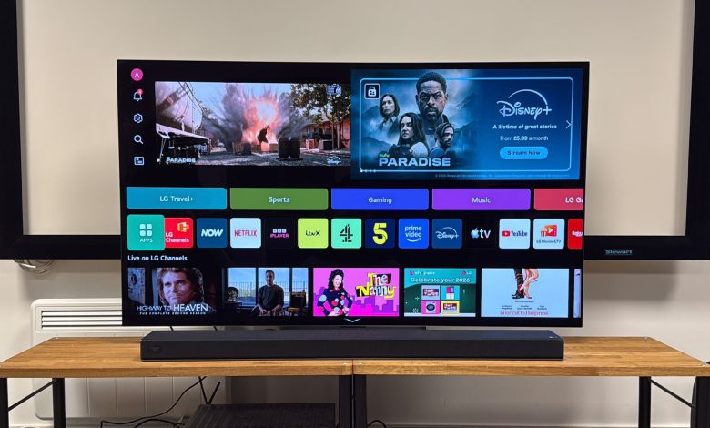 LG Sound Suite H7 soundbar on wooden AV rack below LG TV