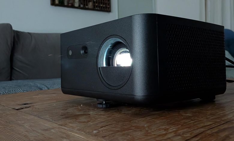 The Optoma Photon Life PK32 projector on a wooden table
