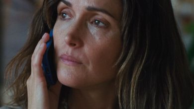 Rose Byrne's character Linda answers the phone and looks off in the distance.