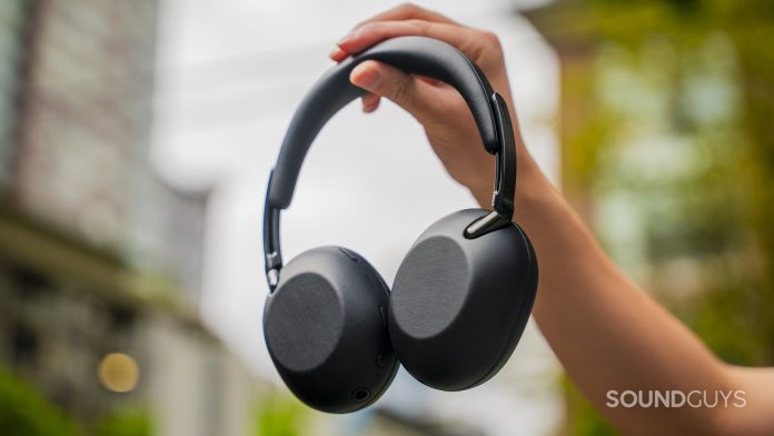 holding the sony the collexion headphones up in the air
