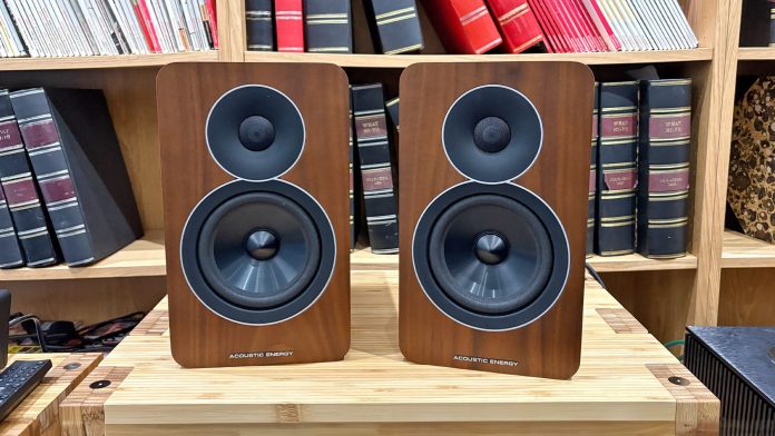 Acoustic Energy AE Active active speakers on hi-fi rack in front of bookcase